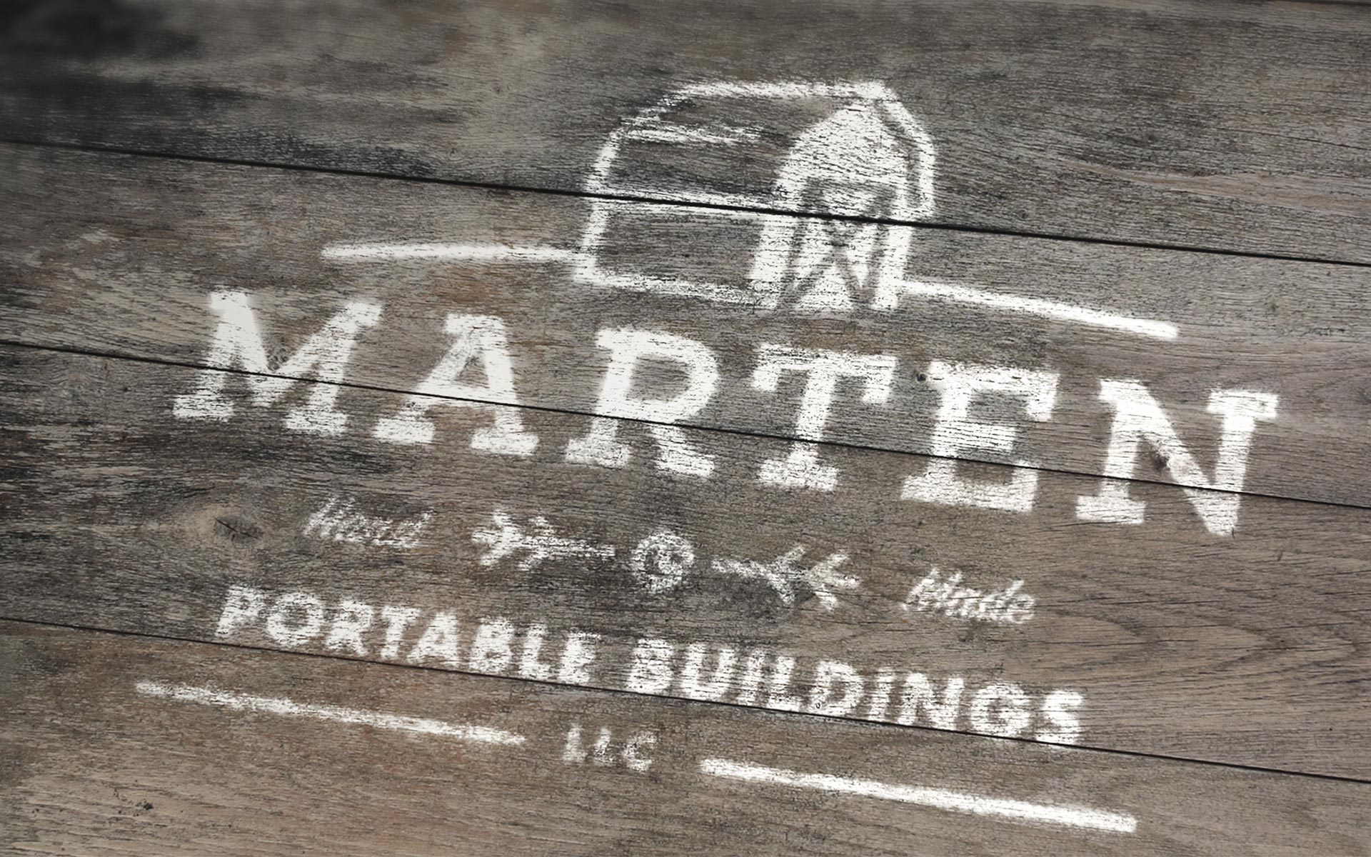 marten portable buildings logo mocked up on wood